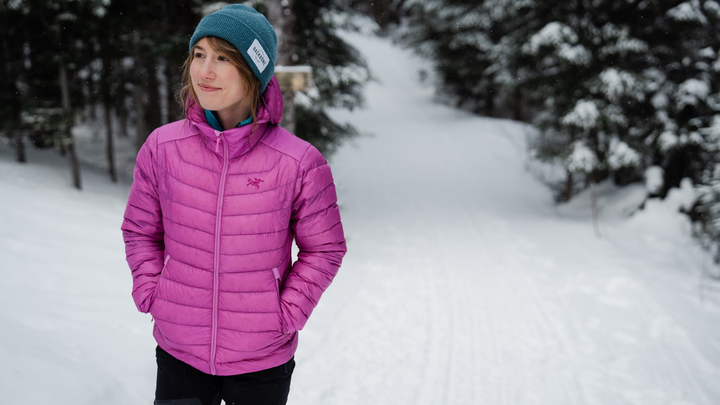 Wearing a pink puffy jacket in the snow