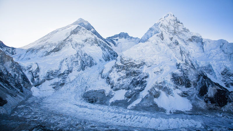 Everest (dark pyramid on left), as seen from the south side in Nepal. Base Camp is located in the lower left corner of photo.