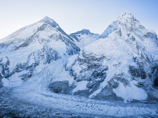 Everest (dark pyramid on left), as seen from the south side in Nepal. Base Camp is located in the lower left corner of photo.