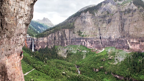 climb climbing via ferrata main telluride rock bridalveil waterfalls colorado iron way pink female climber exposed