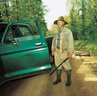 We were foragers once, anf hungry: Jeff Jackson surveys the woods along the road to his Georgia homestead.