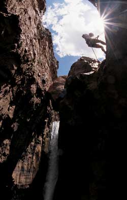 Curius gorge: A canyoneering student rappels into Cibecue Canyon.