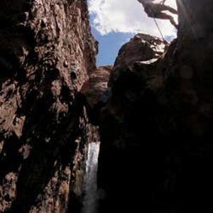 Curius gorge: A canyoneering student rappels into Cibecue Canyon.