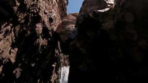 Curius gorge: A canyoneering student rappels into Cibecue Canyon.