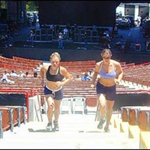 Erica Mitchell and Jamie Cooper sprint up the stairs during Sheryl Crow's sound check.