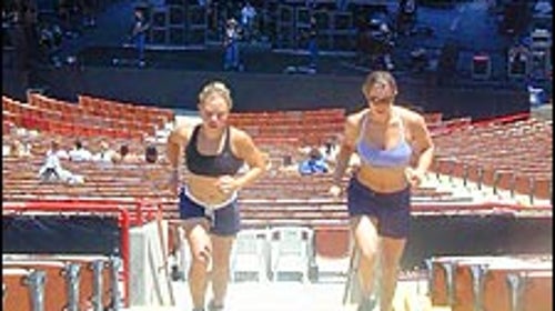 Erica Mitchell and Jamie Cooper sprint up the stairs during Sheryl Crow's sound check.