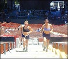 Erica Mitchell and Jamie Cooper sprint up the stairs during Sheryl Crow's sound check.