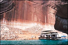 Half empty or half full? Houseboaters examine exposed Lake Powell shoreline