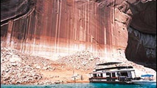 Half empty or half full? Houseboaters examine exposed Lake Powell shoreline