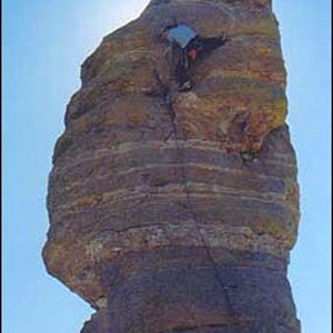 Santa's little climber: one move from the top on Hitchcock Pinnacle at Arizona's Mount Lemmon.