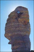 Santa's little climber: one move from the top on Hitchcock Pinnacle at Arizona's Mount Lemmon.