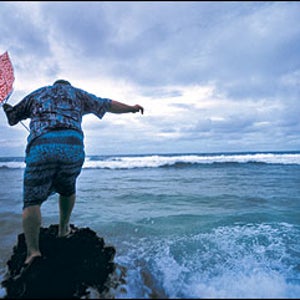 Start bailing: Former Prime Minister Bikenibeu Paeniu braves the incoming swells on Funafuti Atoll.