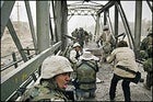 The first wave: Kuni Takahashi (in hat) and Laurent Van Der Stockt document the marine assault on the Diyala Bridge.