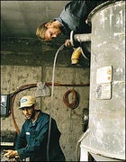 Slippery Hope: biodiesel entrepreneur Charris Ford (bottom), with colleague Nickolai Cowell, at work in their Colorado warehouse