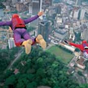 Might as well jump: Californian BASE jumpers Brian Chopin and Henry Boger step off the Menara Kuala Lumpur tower, February 2001.