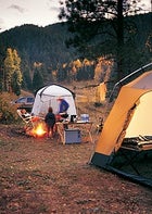 Front to Back: Eureka! tent, L.L. Bean sleeping bag, and Slumberjack cot; Byer table and ARB fridge; Zodi shower (back right), Lafuma chair, and Paha Qué screen house.