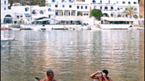 Northwest Passage guides Rick Sweitzer and Mike Agostinelli take a breather in Loutro's port.