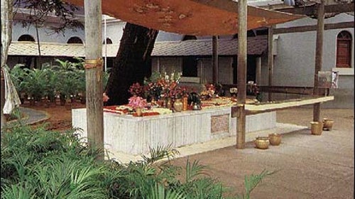 Washing a Large Cooking Pot in an Ashram (India)