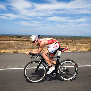 Alexander on his way to breaking the ironman world record; above, more race-day preparation.