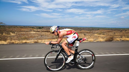 Alexander on his way to breaking the ironman world record; above, more race-day preparation.