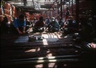 Per villagers talk to Tim Sohn in an unfinished yeu house.