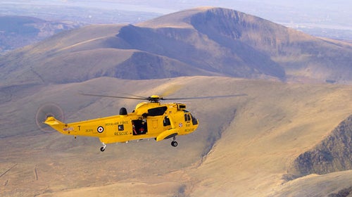 A Royal Air Force helicopter searches for missing climbers