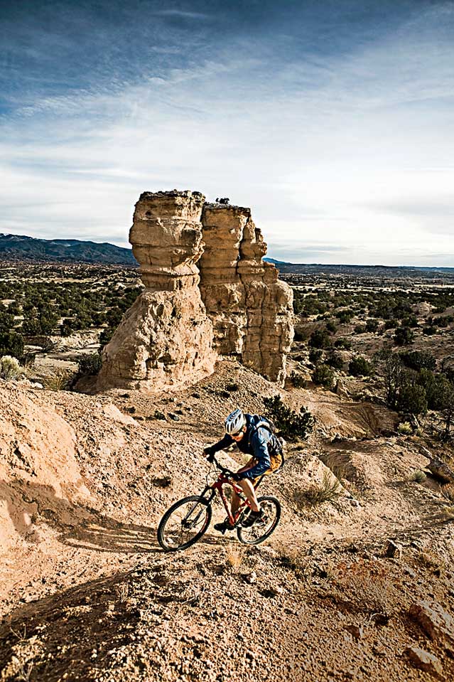 Achievement Arid Climate Awe Beauty In Nature Bicycle Bike Caucasian Appearance Challenge Color Image Copy Space Cycling Cyclist Day Determination Eroded Extreme Terrain Full Length High Angle View Landscape Leisure Activity Majestic Mountain Moving Up Natural Landmark Nature New Mexico One Person One Young Man Only Outdoors Photography Physical Geography Pojoaque Recreational Pursuit Rock Rock Formation Scenics Sports Clothing Sports Helmet Sports Training USA Vertical Vignette Young Adult