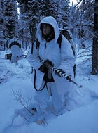 Outfitted in arctic camos, an MWTC marine tries to blend in during a covert ambush drill at Fort Greely Military Reservation, Delta Junction, Alaska.