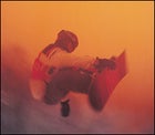 White light, white heat: A competitor surfs above the halfpipe