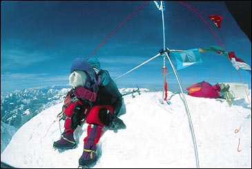 Say cheese: French mountaineer Thierry DeFrance checks his camera near the summit survey marker before descending.