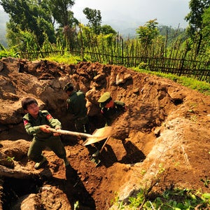 A 14 year old member of the KIA digging a bunker.