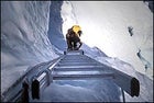 Climbing a ladder on Everest's Khumbu Ice Fall