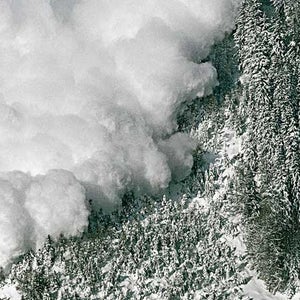 An avalanche rips down a mountainside.