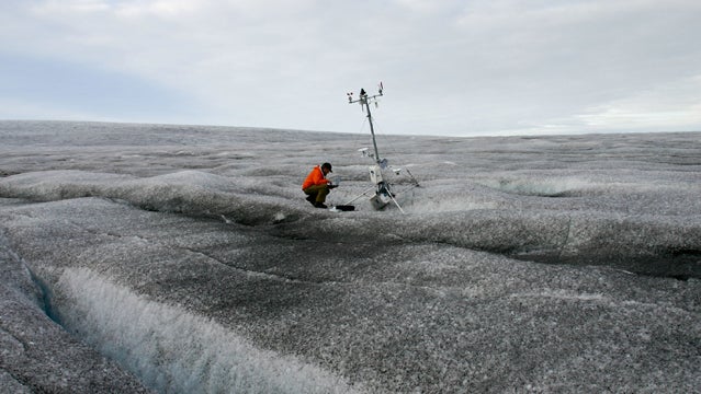 Jason Box at a weather station on Greenland's dark snow.