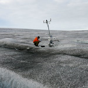 Jason Box at a weather station on Greenland's dark snow.