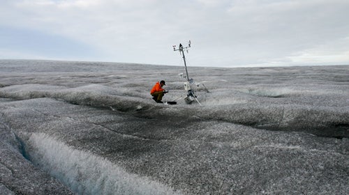 Jason Box at a weather station on Greenland's dark snow.