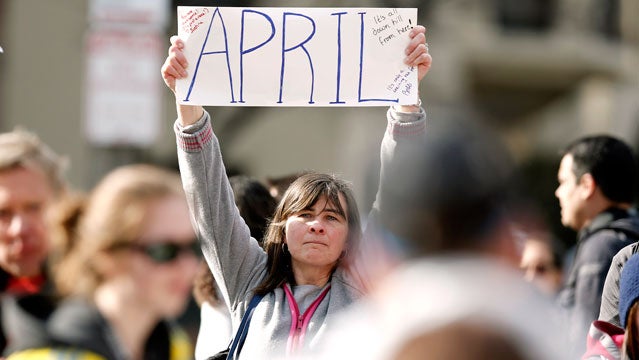 Justine Franco of Montpelier, Vt., holds up a sign near Copley Square in Boston looking for her missing friend, April, who was running in her first Boston Marathon Monday, April 15, 2013. Two bombs exploded near the finish line of the marathon on Monday, killing at least two people and injuring at least 23 others. (AP Photo/Winslow Townson)