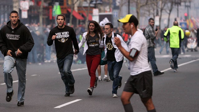 In this photo provided by The Daily Free Press and Kenshin Okubo, people react to an explosion at the 2013 Boston Marathon in Boston, Monday, April 15, 2013. Two explosions shattered the euphoria of the Boston Marathon finish line on Monday, sending authorities out on the course to carry off the injured while the stragglers were rerouted away from the smoking site of the blasts. (AP Photo/The Daily Free Press, Kenshin Okubo) MANDATORY CREDIT