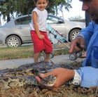 Ruben Ramirez shows the neighborhood kids his latest python.