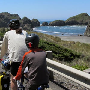 A family rides bikes down the California coast