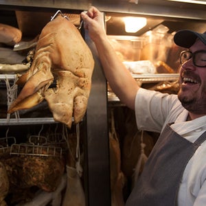 Sean Brock takes stock of a curing hog.