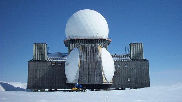 DYE-2 station, snowmobile in front for scale.