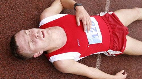 runner lying down running track