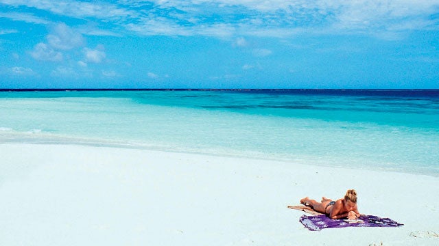 maldives island beach alone reading towel book island trips best travel