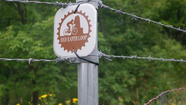 A Red Earth Loop bike trail marker in Negaunee's caving grounds