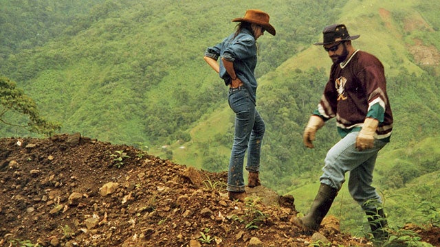 John and Ann inspecting road damage after a landslide.