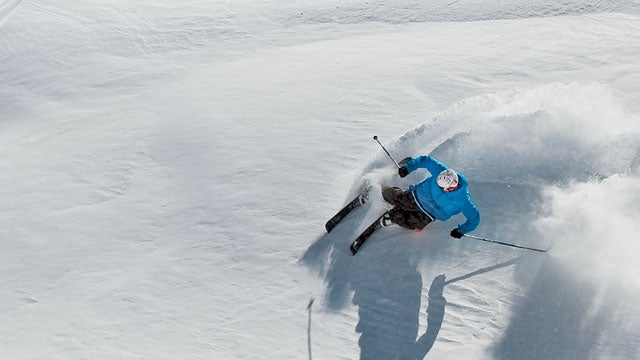 Skier making turns on a sunny powder day at Mount Bachelor Ski Resort.