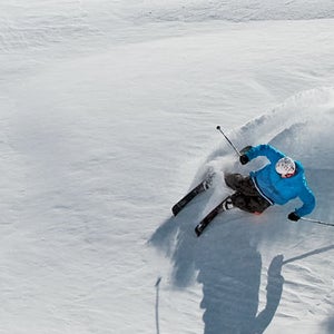 Skier making turns on a sunny powder day at Mount Bachelor Ski Resort.