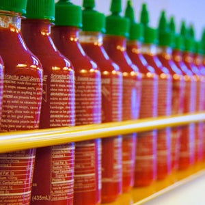 A long line of Sriracha bottles