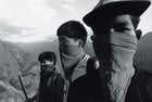 Three masked Maoist militiamen, the author's guides to a guerilla rally in western Nepal.